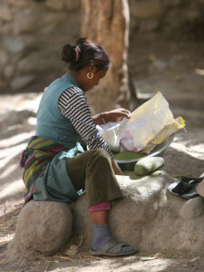 Woman in Ghamni grinding spices in the Mustang region of Nepal