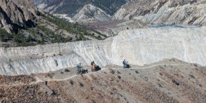 Riders coming along the wall above Gangapurna tal in the Manang valley on the Annapurna circuit trail