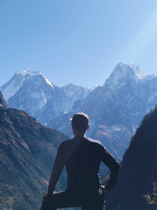 Trekker enjoying the view from the way to the Surti glacier the peaks are Manaslu 8163m and Phungi Himal 6538m. This is a side valley to the Manaslu circuit trek in Nepal